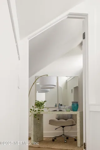 a living room with furniture and chandelier