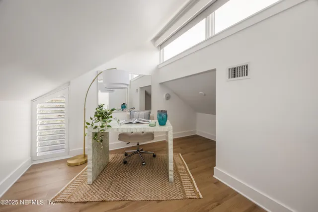 a workspace with wooden floor and a rug