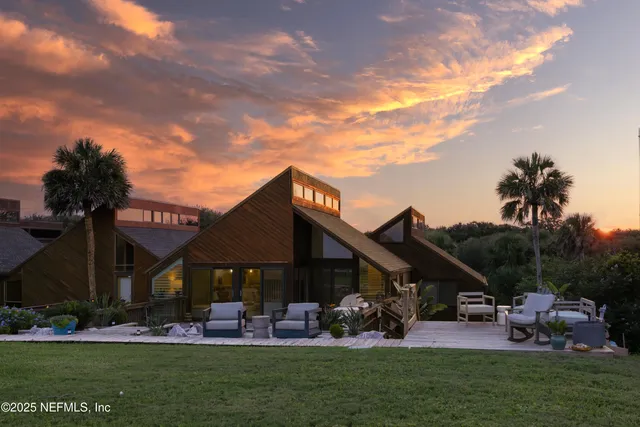 a view of a house with backyard porch and sitting area