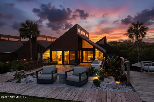 a roof deck with table and chairs potted plants with wooden floor