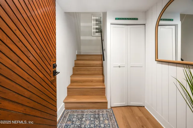 a view of a hallway with wooden floor and windows