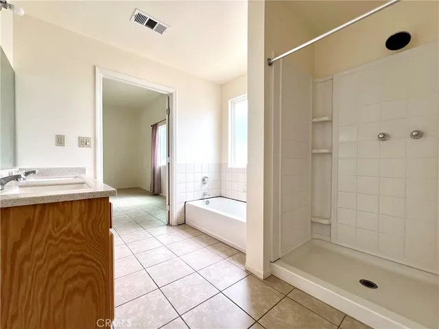 a spacious bathroom with a granite countertop sink and a mirror