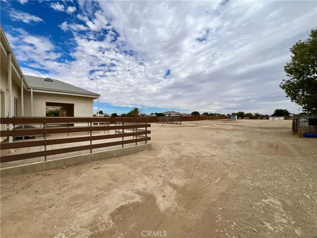 a view of a house with a large tree and a yard