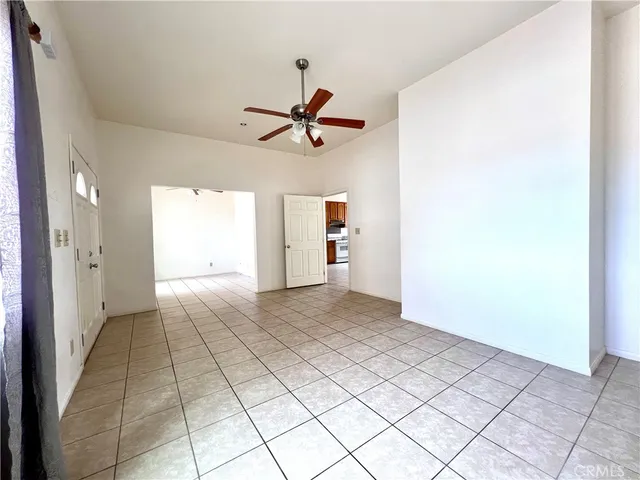 a view of a livingroom with a white cabinets and window