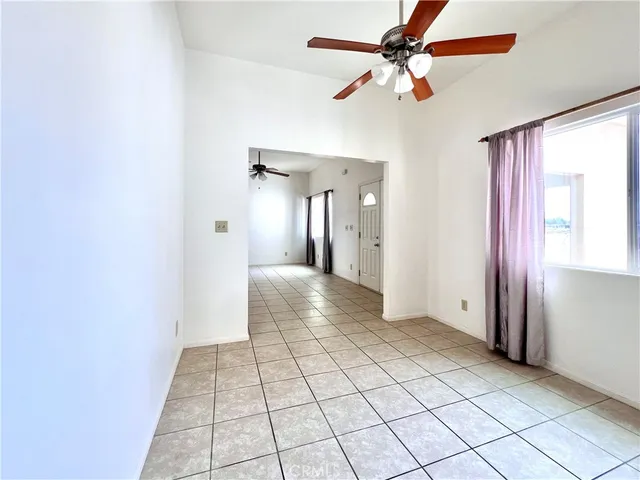a view of an empty room and a ceiling fan