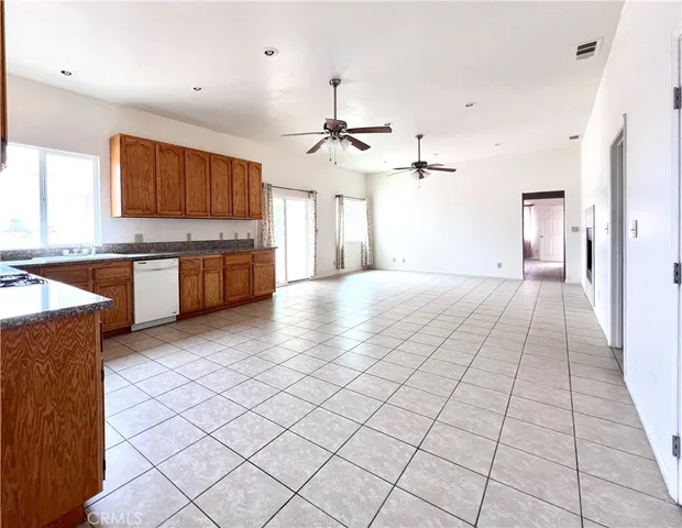 a large kitchen with cabinets in it and wooden floors