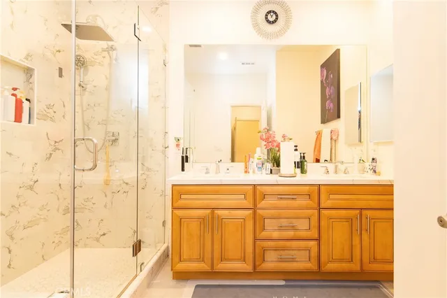 a bathroom with a double vanity sink mirror and