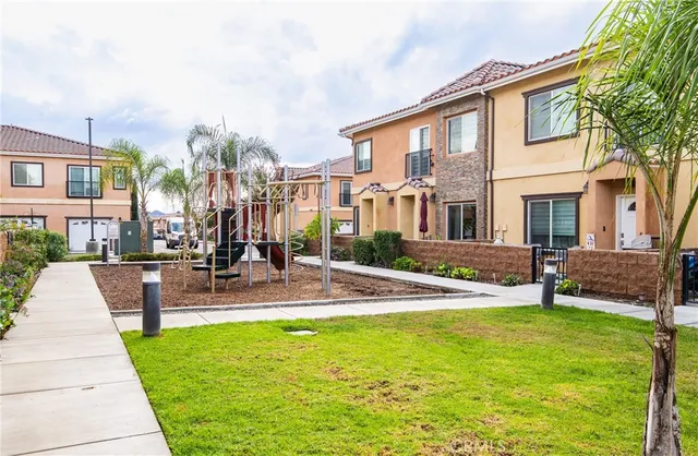 a view of a house with a backyard and a tree