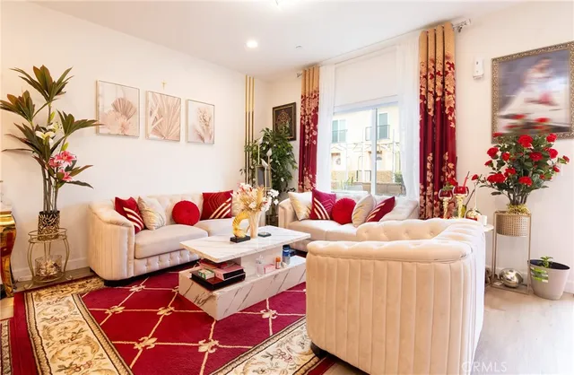 a living room with furniture and flowers