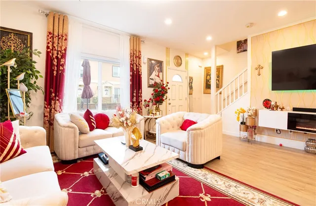 a living room with patio furniture and a flat screen tv