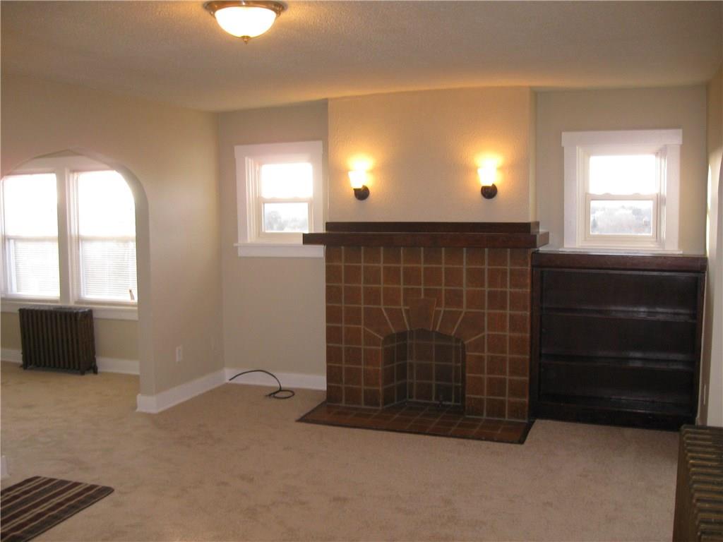 201 Richbarn Road Brighton Heights, PA 15212 - Photo 3 of 11 VIEW OF THE DECORATIVE FIREPLAE AND BULIT IN BOOK CASE ENTERING FROM THE STAIRS