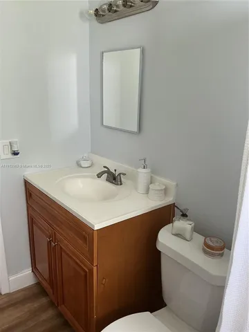 a bathroom with a sink toilet and mirror