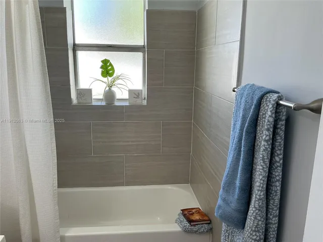 a bathroom with a shower and a bathtub