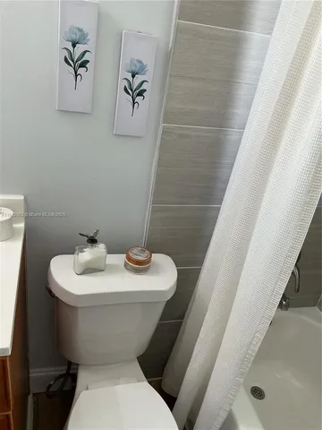 a white toilet sitting next to a bathroom sink