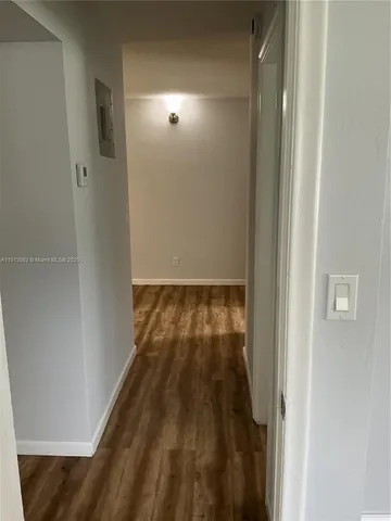 a view of hallway with wooden floor