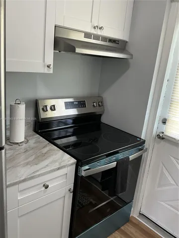 a stove top oven sitting inside of a kitchen
