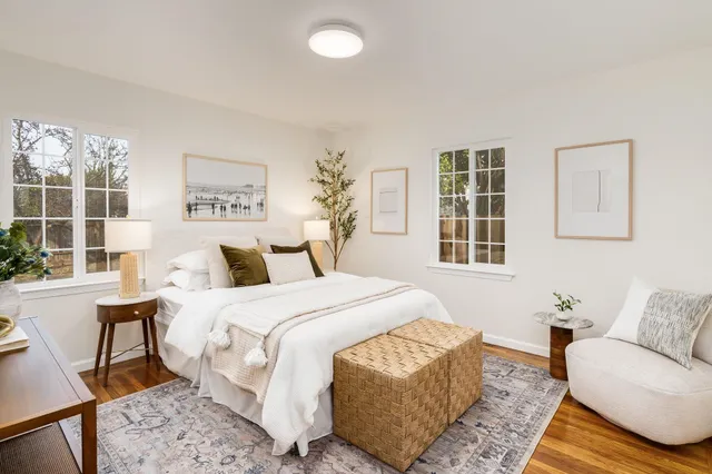 a bedroom with a bed a couch and a window