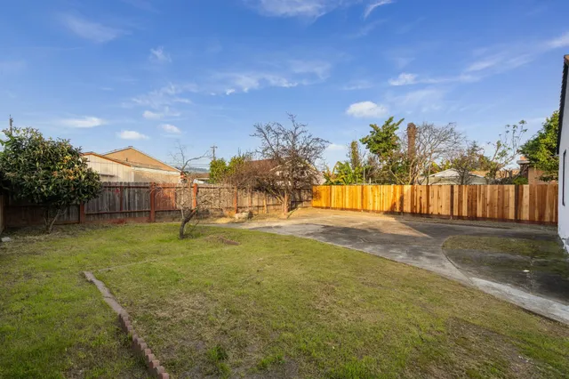 a view of yard with swimming pool and trees