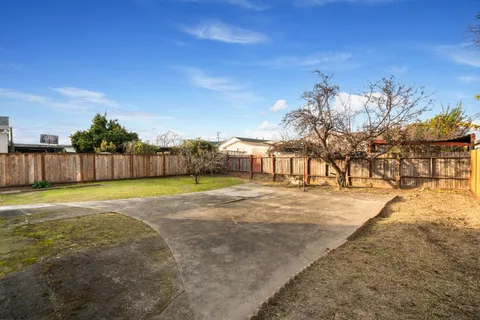 a view of a house with a backyard