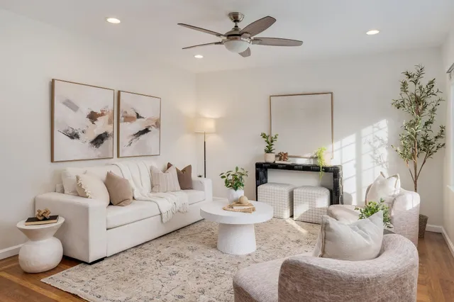 a living room with furniture and a chandelier