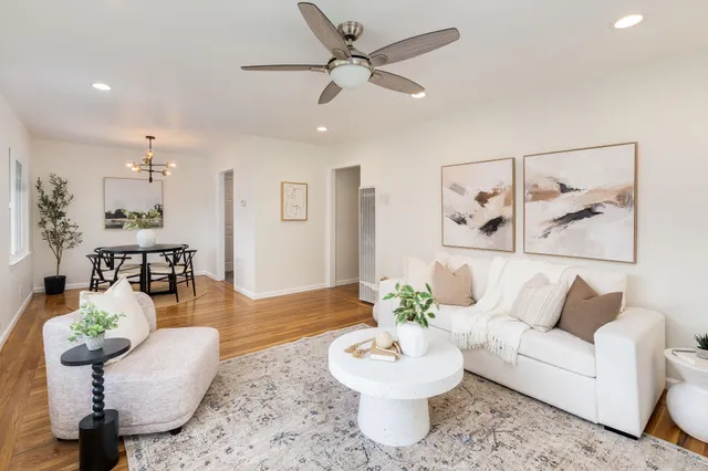 a living room with furniture and a potted plant