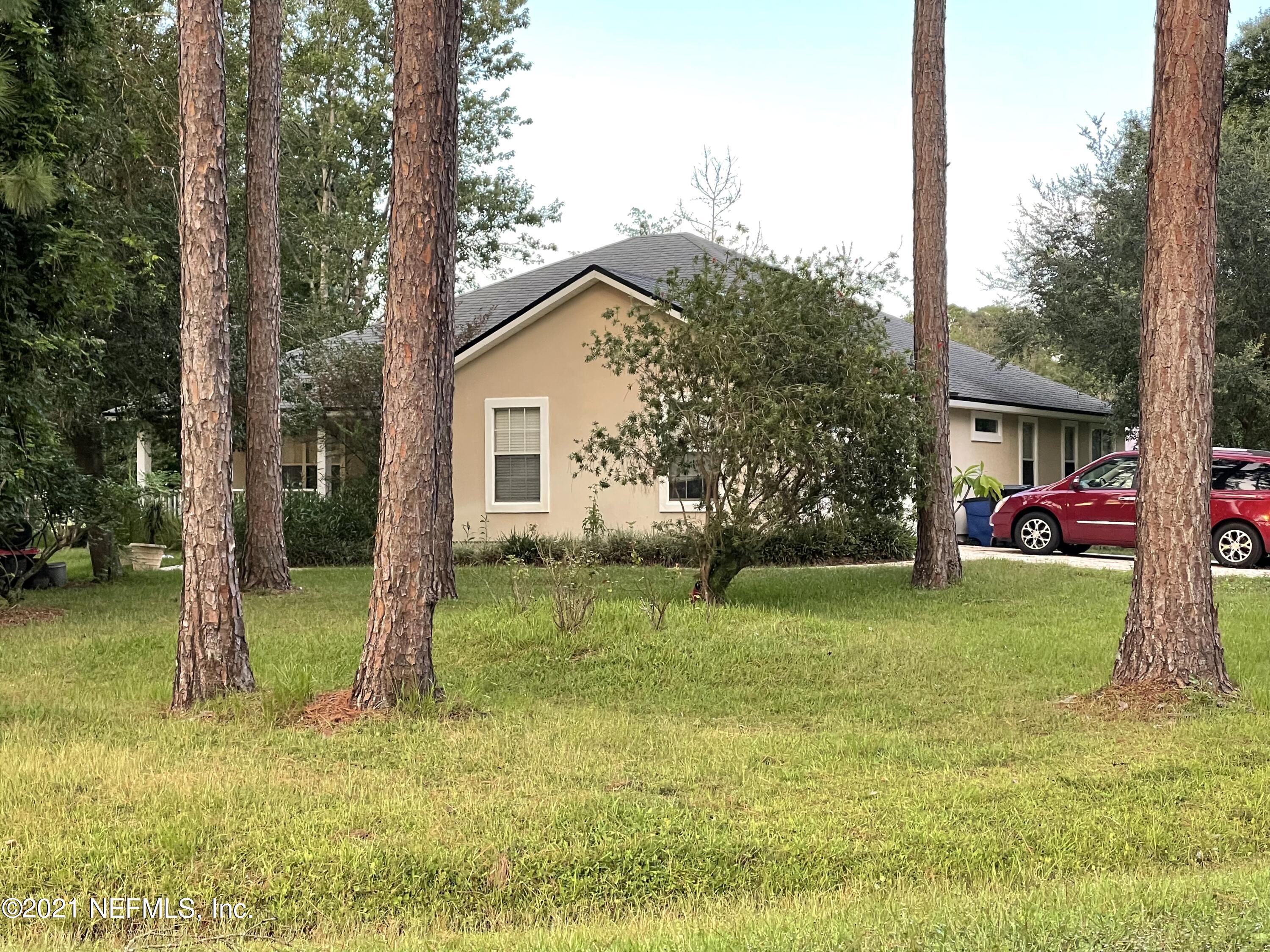 75260 Edwards Road Yulee, FL 32097 - Photo 1 of 1 a backyard of a house with lots of green space