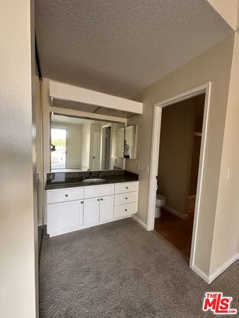 a kitchen with stainless steel appliances a refrigerator sink and wooden floor
