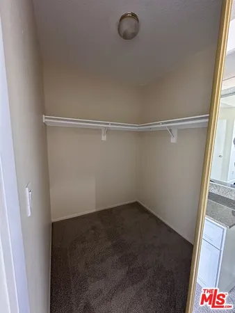 an empty room with wooden floor a fireplace and windows