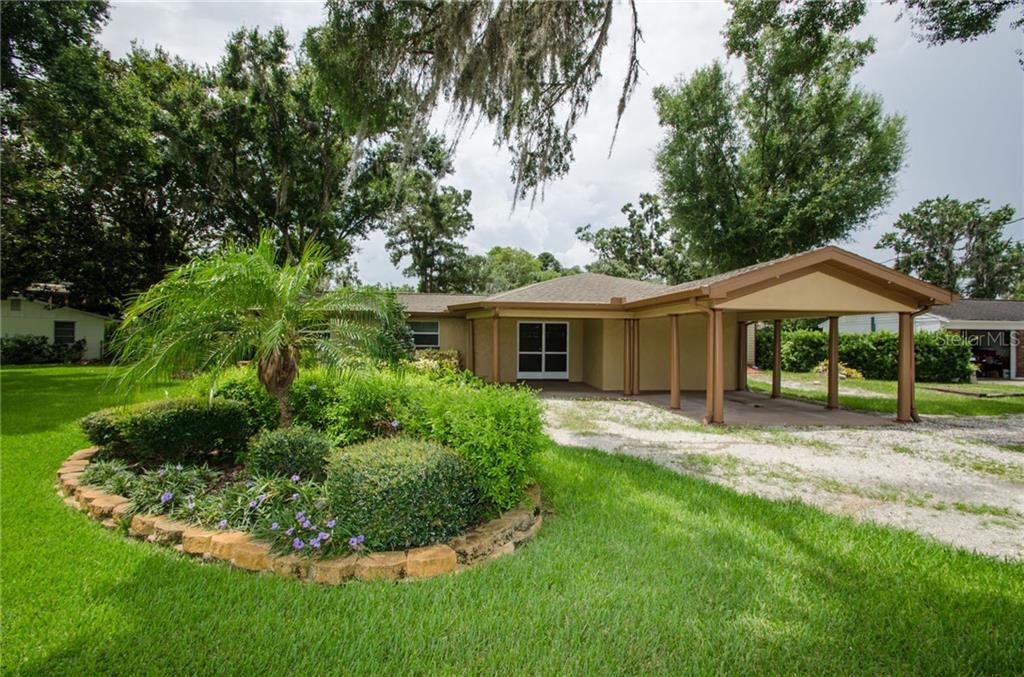 22128 Hale Road Land O' Lakes, FL 34639 - Photo 1 of 1 a front view of house with a garden