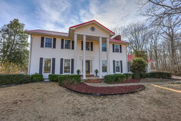 a front view of a house with a yard