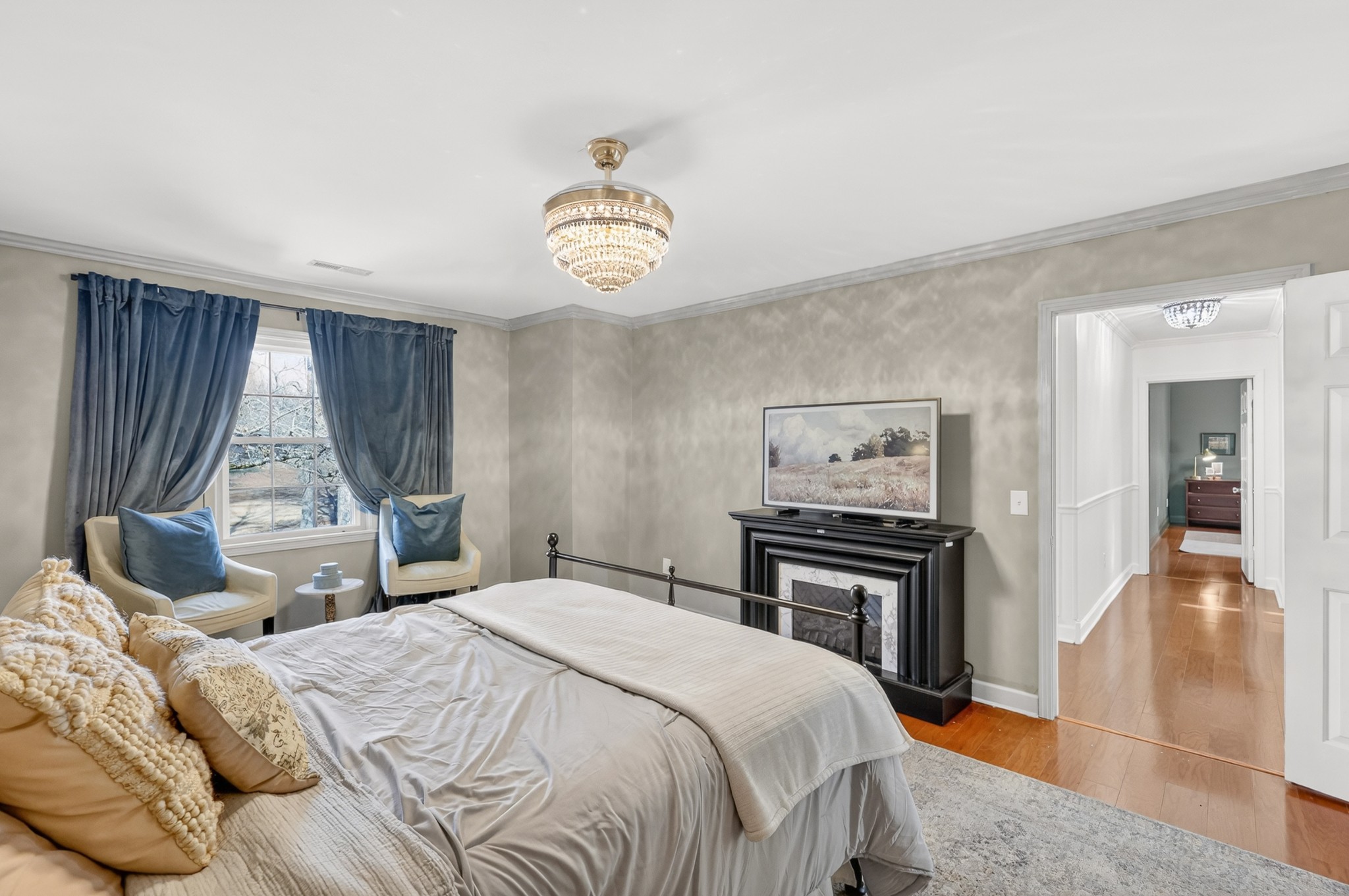 175 Dry Weakley Road Ethridge, TN 38456 - Photo 25 of 49 a bedroom with a bed and a chandelier