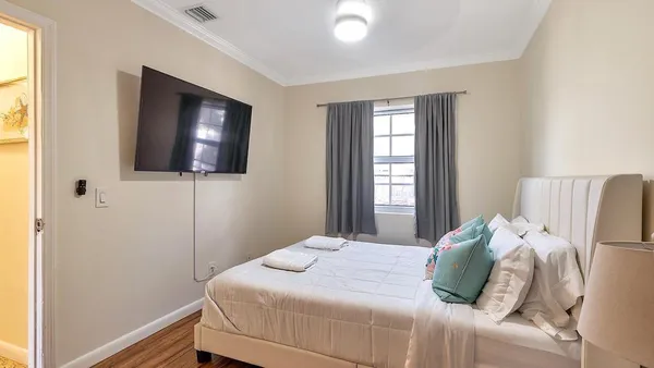 a bedroom with a bed and a flat screen tv