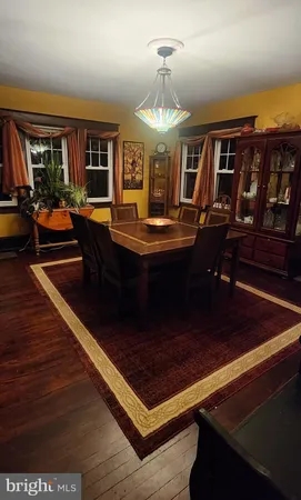 a living room with fireplace furniture and a chandelier