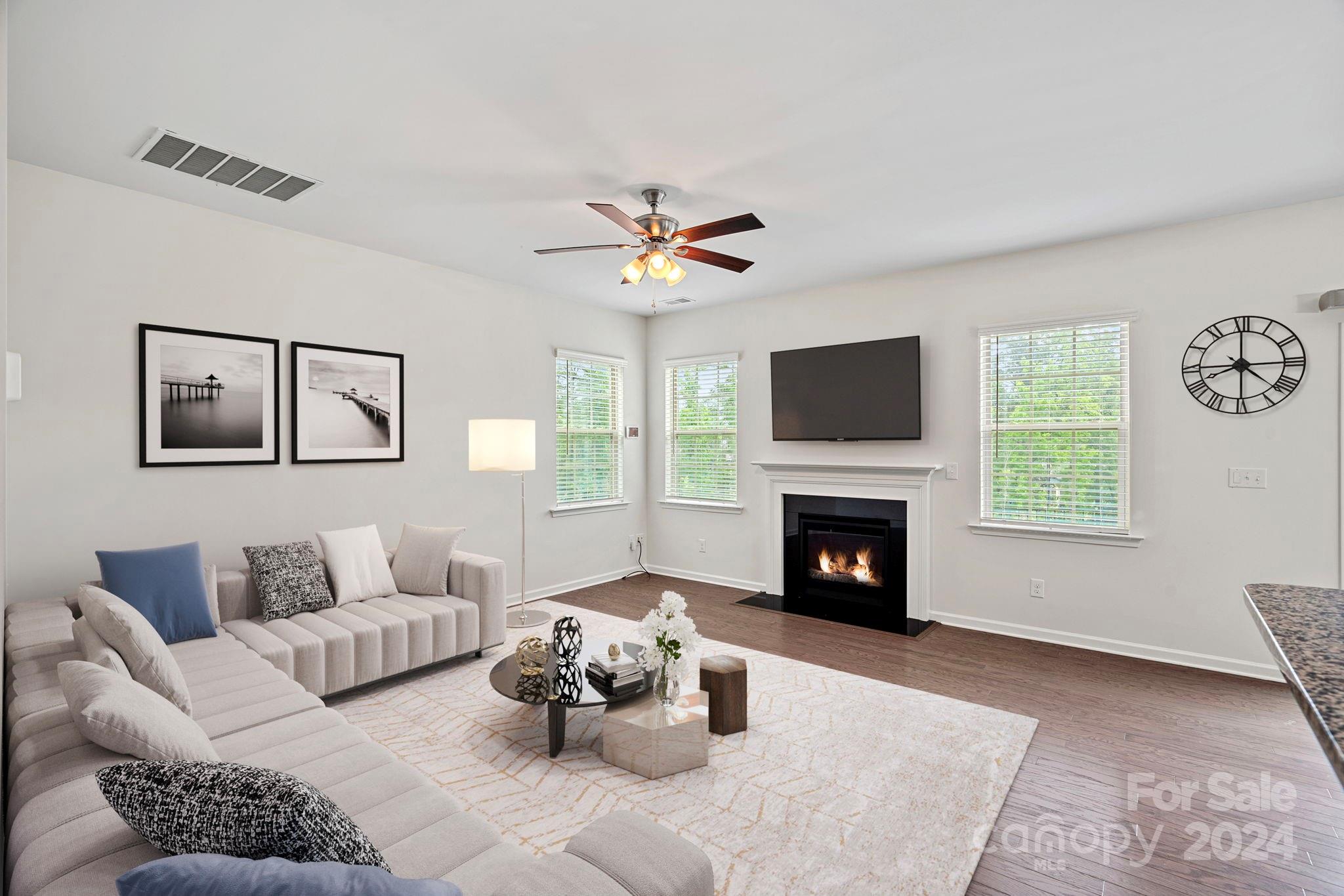 612 Amber Meadows Way Fort Mill, SC 29708 - Photo 3 of 34 a living room with furniture a fireplace and a window