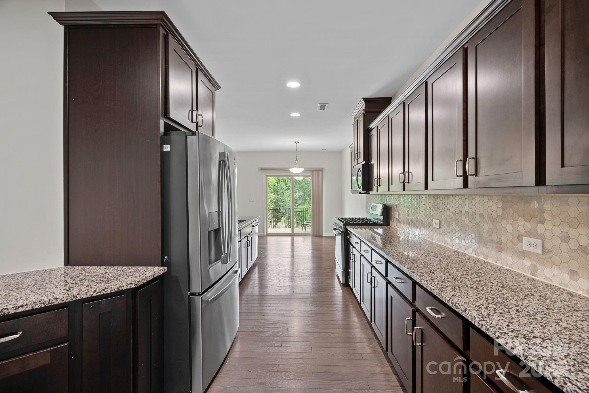 612 Amber Meadows Way Fort Mill, SC 29708 - Photo 5 of 34 a kitchen with granite countertop lots of counter top space and stainless steel appliances