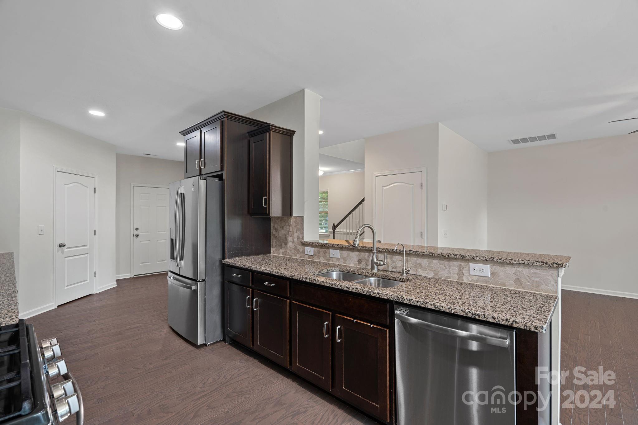612 Amber Meadows Way Fort Mill, SC 29708 - Photo 6 of 34 a kitchen with stainless steel appliances granite countertop a sink and a refrigerator