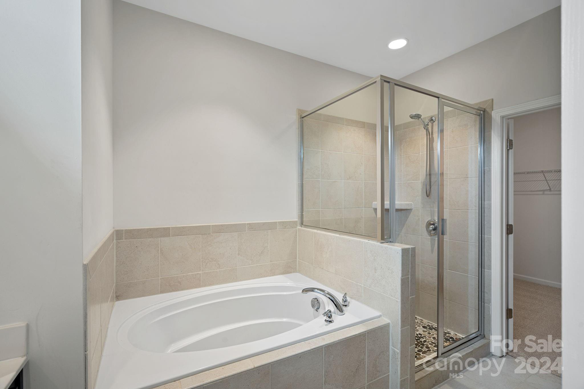 612 Amber Meadows Way Fort Mill, SC 29708 - Photo 10 of 34 a bathroom with a bathtub and a shower