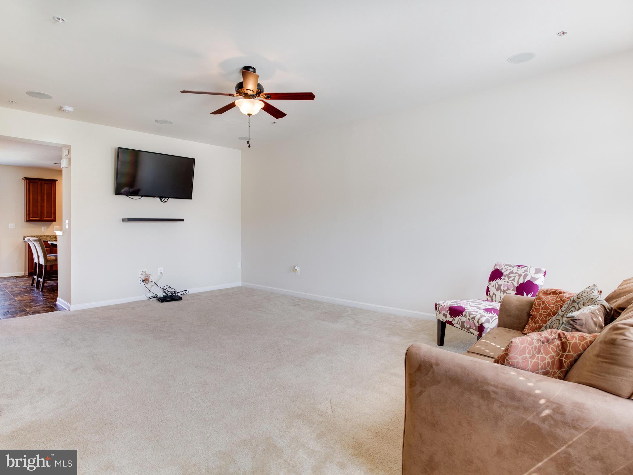 2416 Baileys Pond Road Accokeek, MD 20607 - Photo 22 of 52 a living room with furniture and a flat screen tv