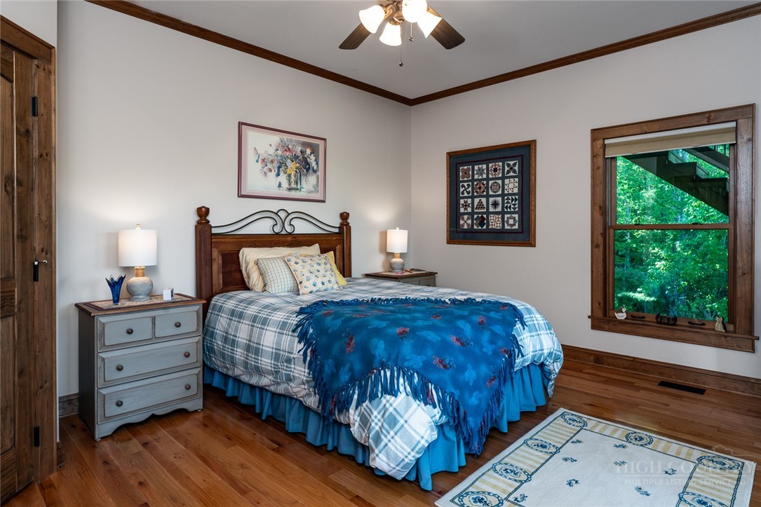 171 Camp Davis Road Banner Elk, NC 28604 - Photo 29 of 48 a bedroom with a large bed and a window