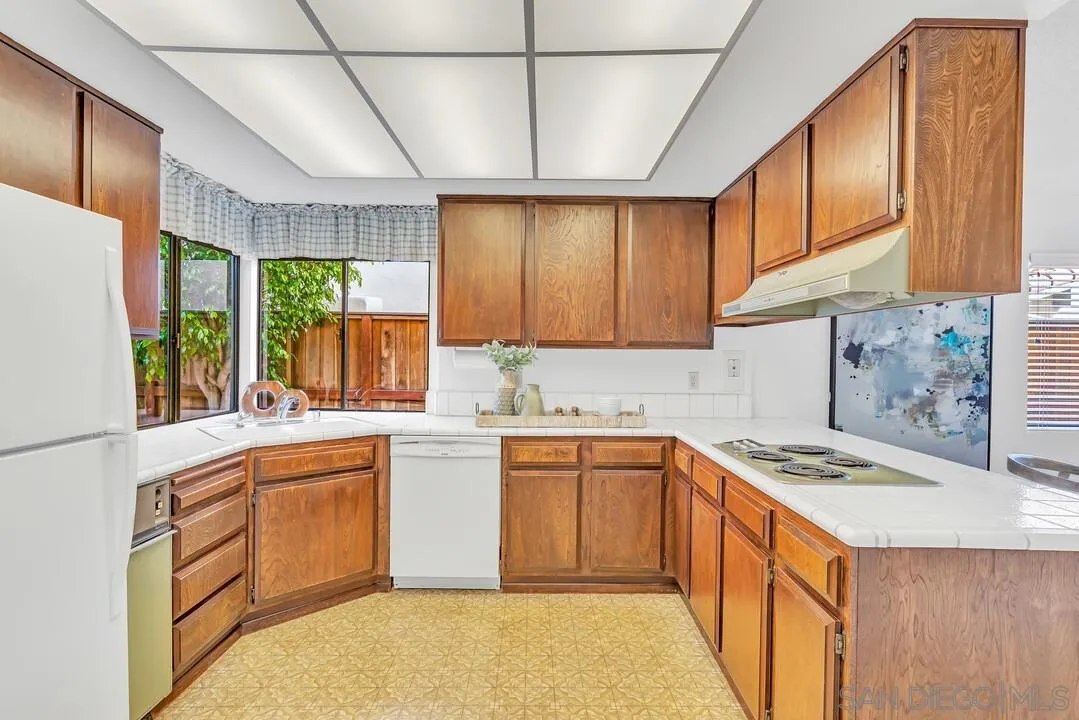 29 Green Turtle Road Coronado, CA 92118 - Photo 30 of 68 a kitchen with a sink stove and cabinets