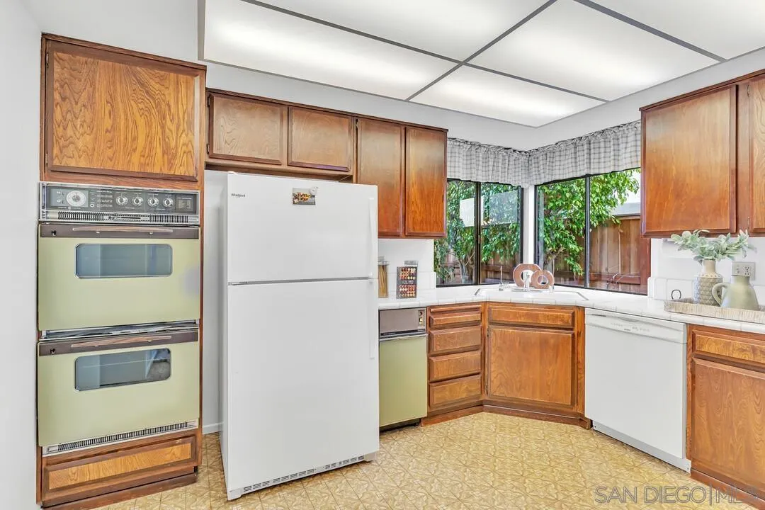 29 Green Turtle Road Coronado, CA 92118 - Photo 32 of 68 a kitchen with appliances a sink and a refrigerator