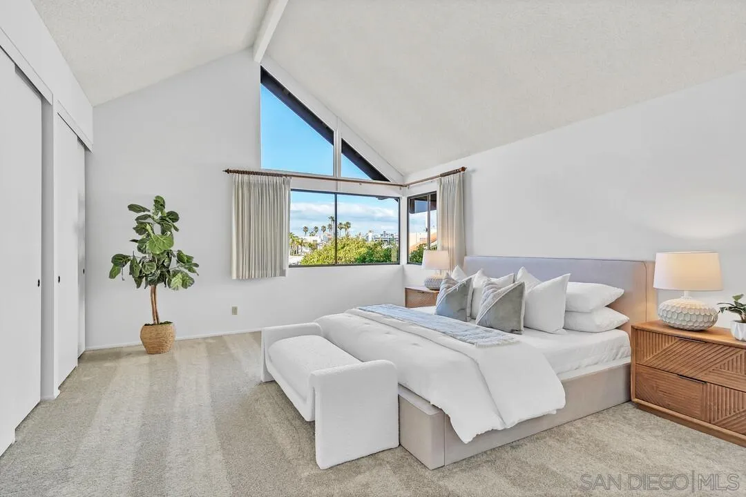 29 Green Turtle Road Coronado, CA 92118 - Photo 41 of 68 a bedroom with a large bed and a potted plant