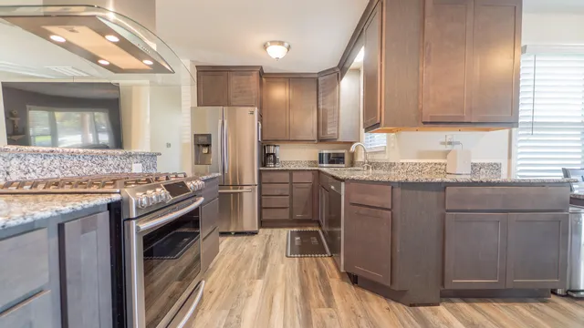 a kitchen with a sink stove and refrigerator