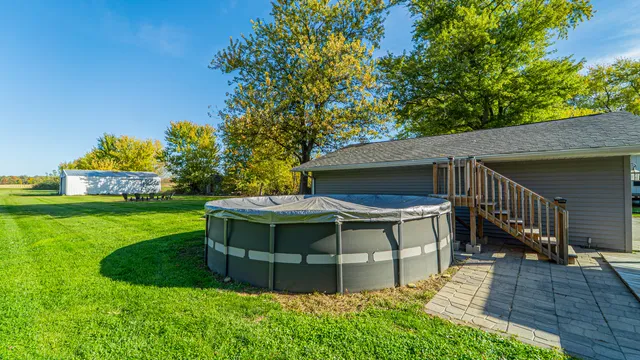 a view of deck with table and chairs a barbeque with wooden floor and fence