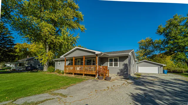a view of a house with a patio and a yard
