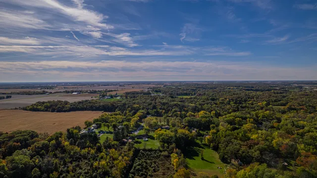 an aerial view of mountain with residential house and ocean view