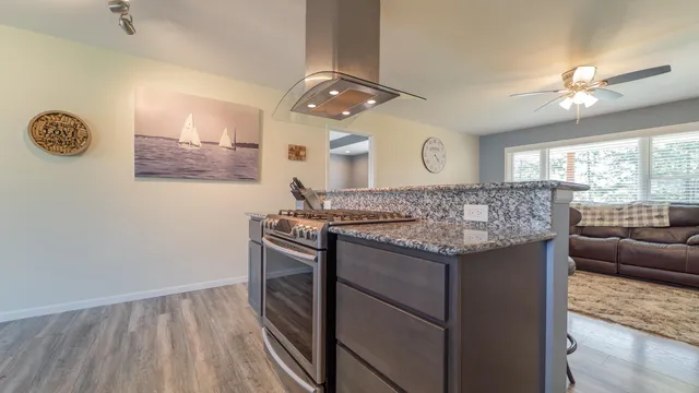 a bathroom with a granite countertop sink a large mirror and a window