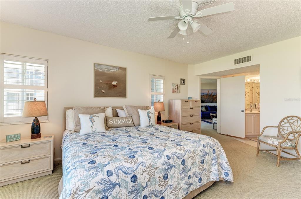 4825 Gulf Of Mexico Drive, Unit 201 Longboat Key, FL 34228 - Photo 13 of 42 a bedroom with a large bed and a chandelier