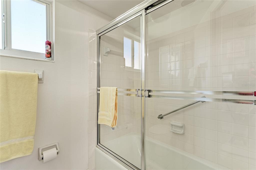 4825 Gulf Of Mexico Drive, Unit 201 Longboat Key, FL 34228 - Photo 16 of 42 a bathroom with a shower and a bath tub