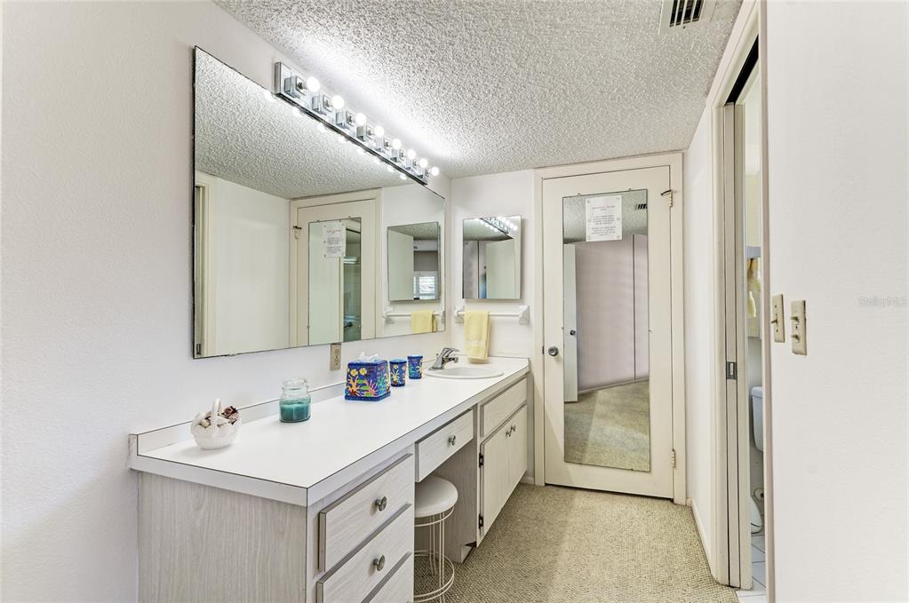 4825 Gulf Of Mexico Drive, Unit 201 Longboat Key, FL 34228 - Photo 17 of 42 a bathroom with a sink double vanity and a mirror